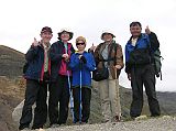 Tibet Kailash 10 Kora 07 Finished Team Photo Here is our happy team after completing the Kailash kora. Paldi and Pemba Rinji were already at the truck. From left to right: me, Charlotte, Pete, Sue, and Gyan.